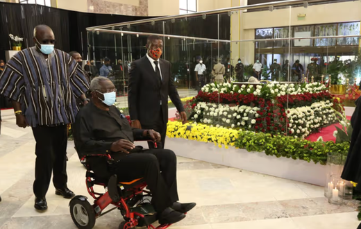 Ex-President John Agyekum Kufuor filing past the remains of the late former President Jerry John Rawlings in January, 2021, while sitting in a wheelchair