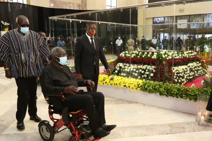 Ex-President John Agyekum Kufuor filing past the remains of the late former President Jerry John Rawlings in January, 2021, while sitting in a wheelchair
