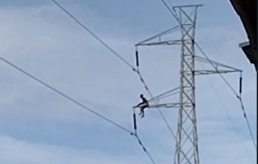 Man climbs pylon