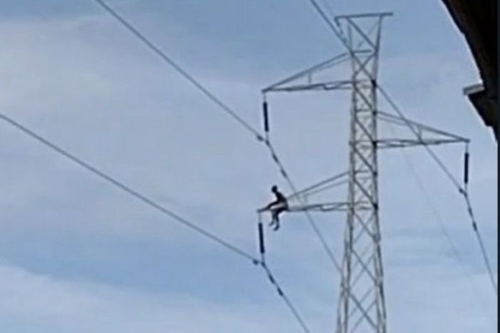 Man climbs pylon