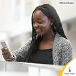 A lady using her phone to buy Kenya Power tokens