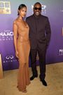 Idris Elba kept things classic with an all-black suit, while his wife, Sabrina Dhowre Elba, wore a floor-length tan dress.