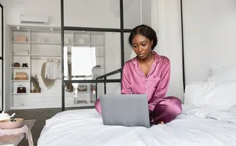 Dangers of using your laptop in bed [Depositphotos]