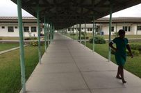 A lone nurse walks through Winneba Trauma and Specialist Hospital in Winneba, Ghana, August 20, 2015. Doctors in Ghana will suspend a three-week strike they called to press for better conditions of service, the Ghana Medical Association (GMA) said on August 21. The 125-bed hospital is almost empty because of a partial strike by doctors who have withdrawn emergency and out-patient services to press for better pay and conditions. Picture taken August 20, 2015.  REUTERS/Matthew Mpoke Bigg