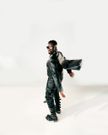 His outfit was completed with black leather boots and a statement silver helmet, evoking a futuristic, almost sci-fi look