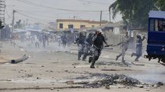 Demonstrators engage police during a protest calling for President Faure Gnassingbe's resignation in Lome, Togo on June 26. (AP)