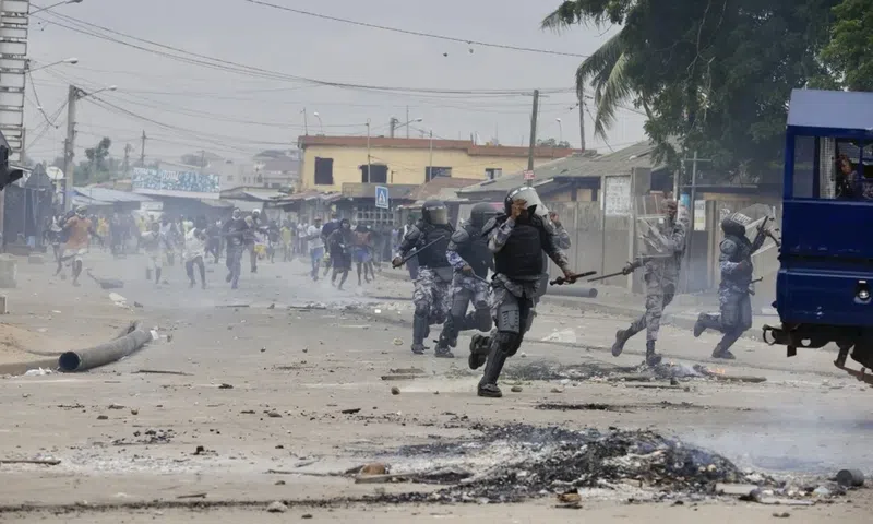 Demonstrators engage police during a protest calling for President Faure Gnassingbe's resignation in Lome, Togo on June 26. (AP)