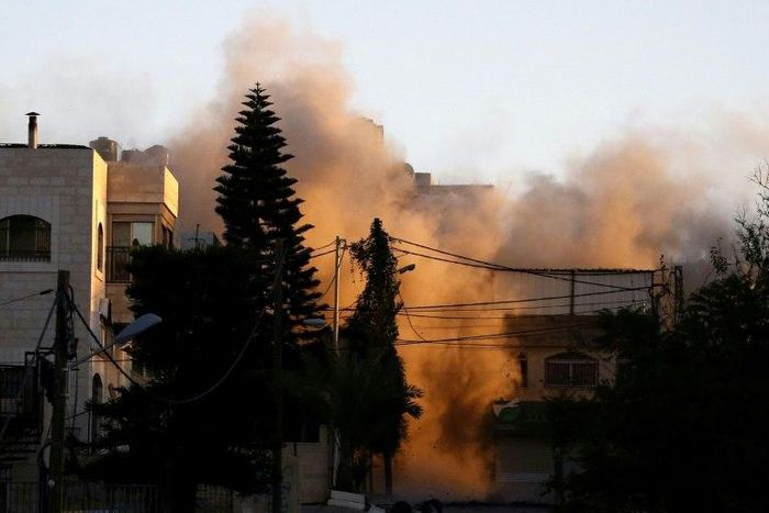 Israeli troops demolish the home of Islam Abu Hamid, a Palestinian who was arrested for the June killing of a soldier, completing a night-ling incursion into the Palestinian-controlled West Bank city of Ramallah