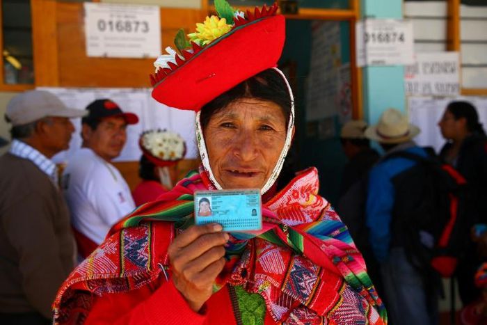 A voter in Ollantaytambo, near the ancient imperial Inca capital of Cuzco, shows her identity card as Peruvians voted on constitutional reforms aimed at curtailing corruption