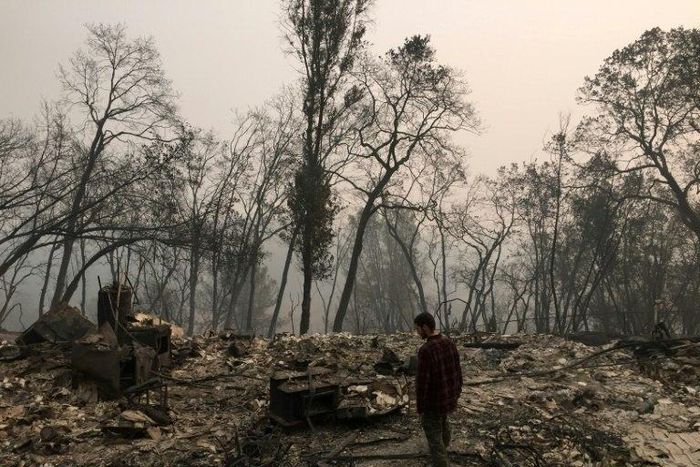 Jhonathan Clark walks in what was his house, destroyed by the Camp Fire, in Paradise -- his brother is among the missing