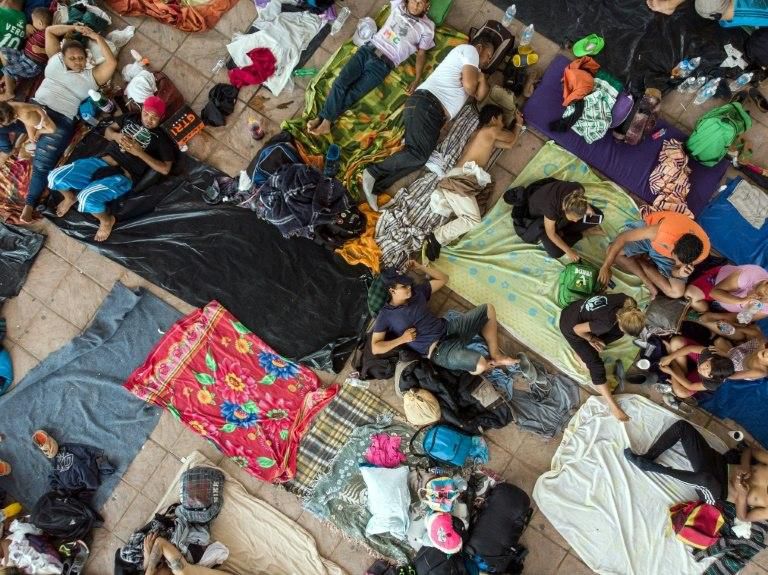 Honduran migrants rest in the main square of Pijijiapan, Chiapas state, Mexico, the latest stop on the caravan heading to the US