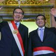 Handout picture released by the Peruvian presidency press office of President Martin Vizcarra (L) and newly appointed Interior Minister Carlos Moran, waving during a swearing-in ceremony at government headquarters in Lima on October 19, 2018.