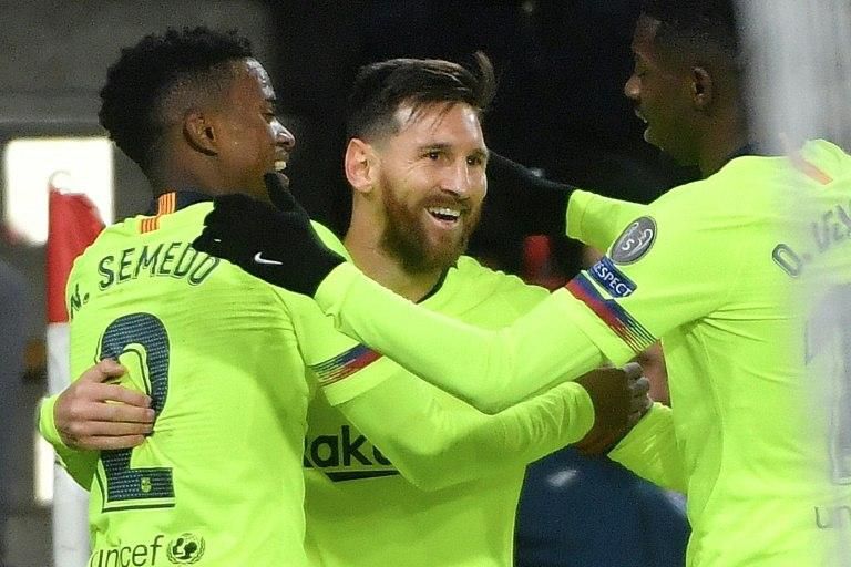 Barcelona's Lionel Messi celebrates scoring in his side's 2-1 victory over PSV Eindhoven to claim top spot in their Champions League group