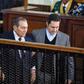 Former Egyptian president Hosni Mubarak (C), who was ousted during a popular uprising in 2011, is escorted by his two sons Alaa (R) and Gamal (L) for a session in the retrial of members of the now-banned Muslim Brotherhood