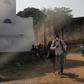 People in Beni escaped from teargas during a protest against the postponement of elections in their region