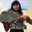 Grace Subathirai Nathan, whose mother Anne Daisy was on board Flight MH370, shows a piece of debris believed to be part of the ill-fated plane