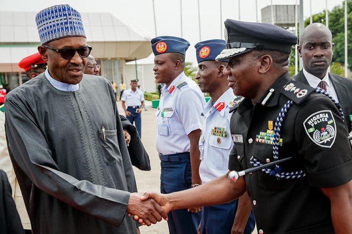 President Muhammadu Buhari shakes hands with Inspector-General of Police, Ibrahim Idris