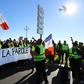 Protestors hold a banner reading "The people speak out" during a protest of 'yellow vests' against rising fuel prices and living costs, in the southern French city of Nice on December 8, 2018