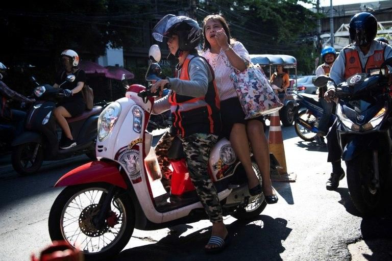 Bangkok's motortaxi drivers live on the edge, weaving skillfully between long lines of cars