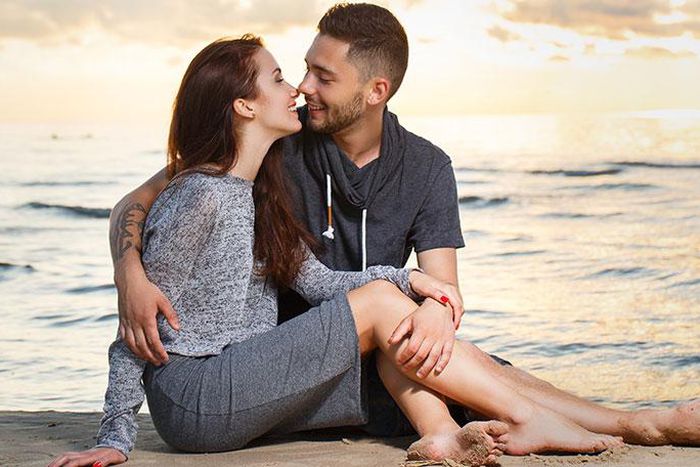 Photo of two passionate friends cuddling on the beach (LovePanky)