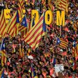 People wave pro-independence Catalan flags 'Esteladas' during a pro-independence demonstration in Barcelona on September 11, 2018