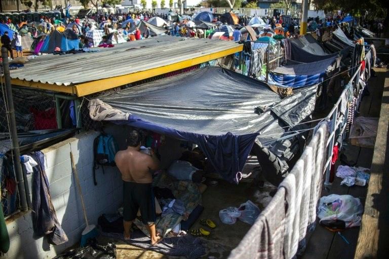 Central American migrants are crammed into a makeshift shelter in Tijuana, Mexico as they wait in hope of crossing into the US