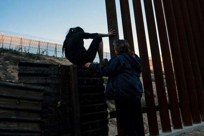 The UN General Assembly formally ratified the UN Global Compact for Safe, Orderly and Regular Migration -- here, a group of Central American migrants hover near the US-Mexico border, mulling whether to try to cross