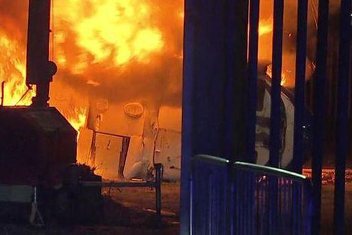 The crashed helicopter outside the stadium