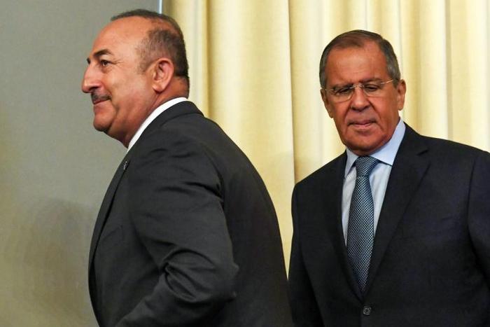 Russian Foreign Minister Sergei Lavrov (R) and his Turkish counterpart Mevlut Cavusoglu, pictured August 2018, met to coordinate ground operations in Syria after the announced US military pullout