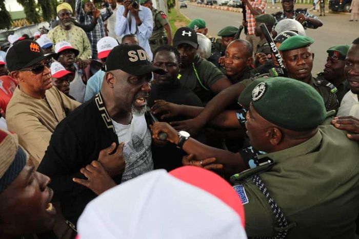 Senator Dino Melaye clashes with police officers at Abuja protest