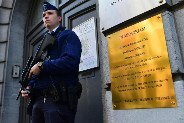 A policeman stands guard at the entrance of the Jewish Museum of Belgium in central Brussels after the unveiling of a plaque in memory of the four people shot dead there by a suspected jihadi extremist who had returned from Syria