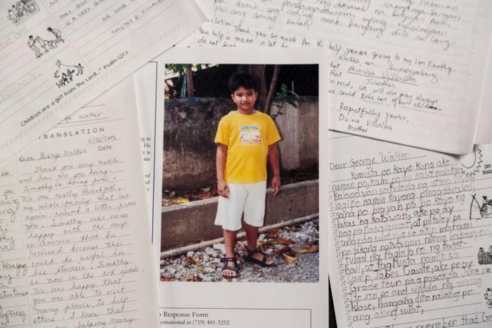 Timothy, then a seven-year-old Filipino boy, is shown in a photograph with a letter he sent to his pen pal, former US President George H.W. Bush, who sponsored him for 10 years using a pseudonym