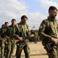 Members of the People's Protection Units (YPG) attend the funeral of fellow Kurdish fighters who were killed in combat against Islamic State (IS) group in Deir Ezzor, on March 3, 2018, in Qamishli
