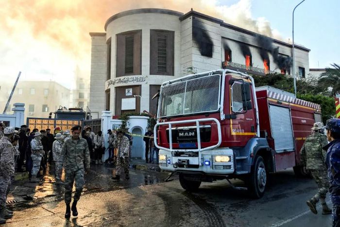 A fire truck and security officers outside Libya's foreign ministry in the capital Tripoli on December 25, after an attack that was claimed by Islamic State