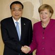 German Chancellor Angela Merkel (R) shakes hands with China's Prime Minister Li Keqiang ahead of a meeting on the sidelines of an EU-ASEM leaders meeting at the European Council in Brussels on October 19, 2018