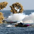 South Korean Marine amphibious assault vehicles fire smoke shells during a landing operation in the southern city of Pohang