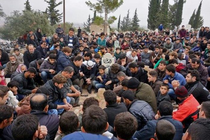 Mourners attend the funeral of citizen journalists Raed Fares and Hamod Jnaid, who were "shot dead by unknown assailants" in the village of Kafr Nabel in the northwestern province of Idlib