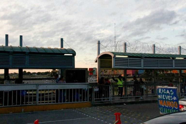Concertina wire can be seen installed all the way up to the US-Mexico border on this busy international bridge at the frontier between Nueva Laredo, Mexico (L) and Laredo, Texas, (R)
