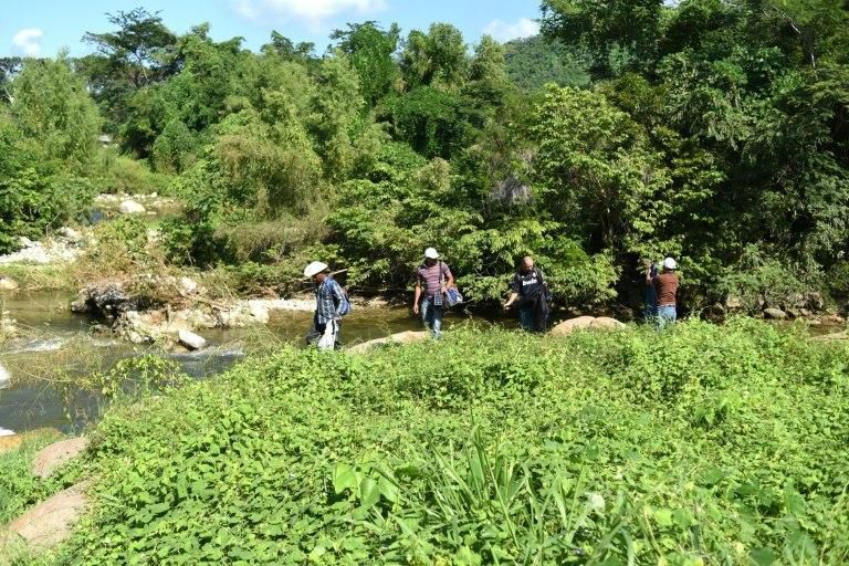 Honduran migrants (L-R) Jorge Almendarez, 39, Erick Garrido, 36, Denis Turcias, 23, and Rudy Valdez, 31, who became friends in the caravan heading to the US, walk in Pijijiapan, Chiapas state, Mexico, on their journey north