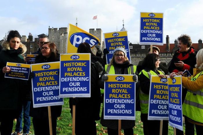 Historic Royal Palaces staff hold placards on a picket line, striking strike over pensions outside the Tower of London