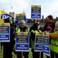 Historic Royal Palaces staff hold placards on a picket line, striking strike over pensions outside the Tower of London