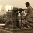 This image grab taken from a AFPTV video shows Yemeni pro-government forces firing a heavy machine gun at the south of Hodeida airport, in Yemen's Hodeida province on June 15, 2018