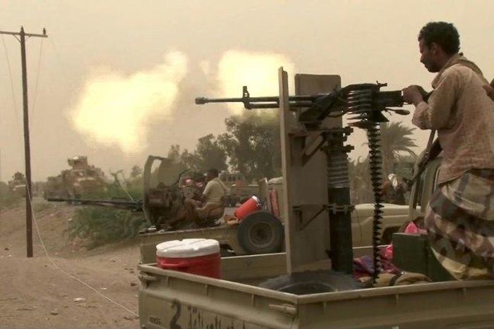 This image grab taken from a AFPTV video shows Yemeni pro-government forces firing a heavy machine gun at the south of Hodeida airport, in Yemen's Hodeida province on June 15, 2018