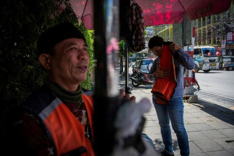 The distinctive orange jackets worn by Bangkok's 'motorsai'