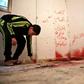 A Palestinian boy checks a shrapnel-riddled room with blood stains in the West Bank refugee camp of Asker near Nablus on December 13, 2018 after Israeli forces killed a Palestinian suspected of having murdering two Israelis
