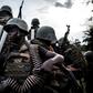 Soldiers from the Armed Forces of the Democratic republic of the Congo (FARDC) are seen gearing up as gunfire erupts close by on October 7, 2018 outside Oicha Attacks on FARDC bases by the ADF has become more common. The ADF usually attack at night ove...