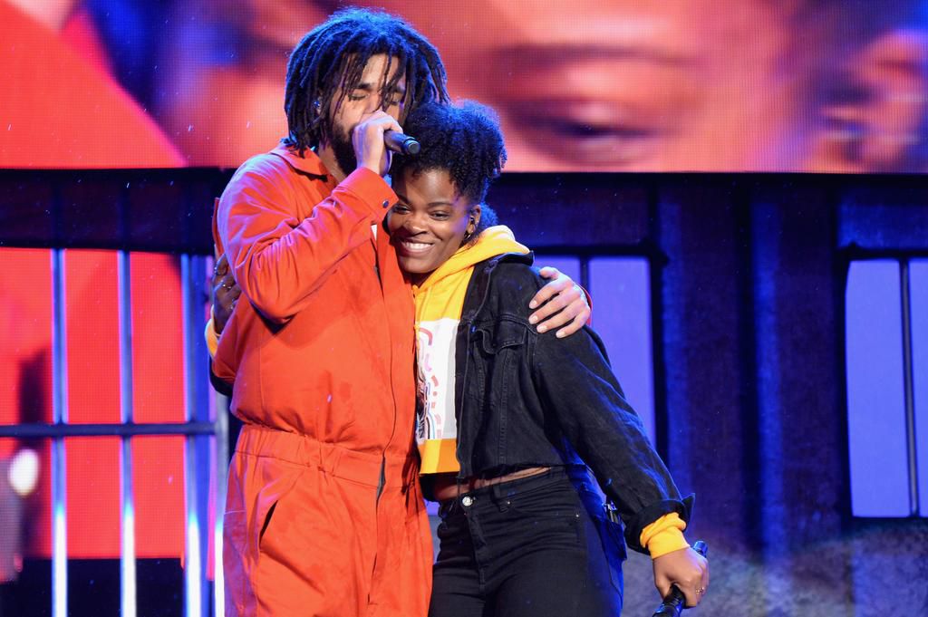 Ari lennox and J Cole on stage [Essence]