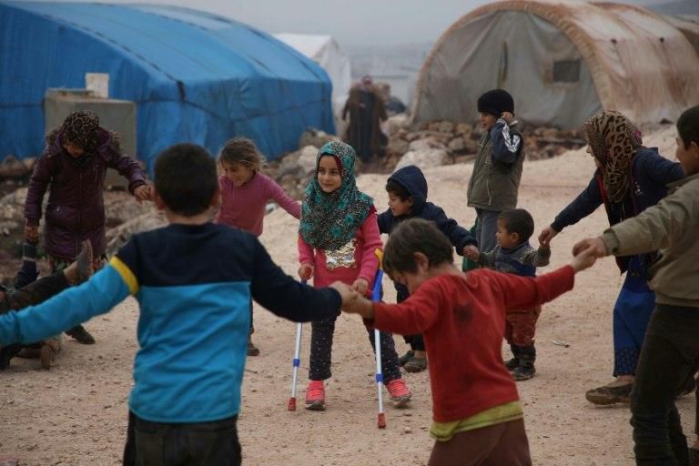 Since getting her prosthetics, Maya Merhi has been able to play with her friends at the Serjilla camp in northwestern Syria