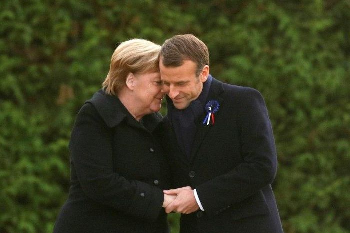Germany is taking a softly-softly approach to French President Emmanuel Macron's easing of the budget strings to cope with protests, with Chancellor Angela Merkel (right) focussing on stability in Europe, analysts say