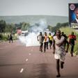 Supporters of Democratic Republic of Congo opposition leader Martin Fayulu run as police teargas fills on December 19, 2018 in Kinshasa, after a demonstration